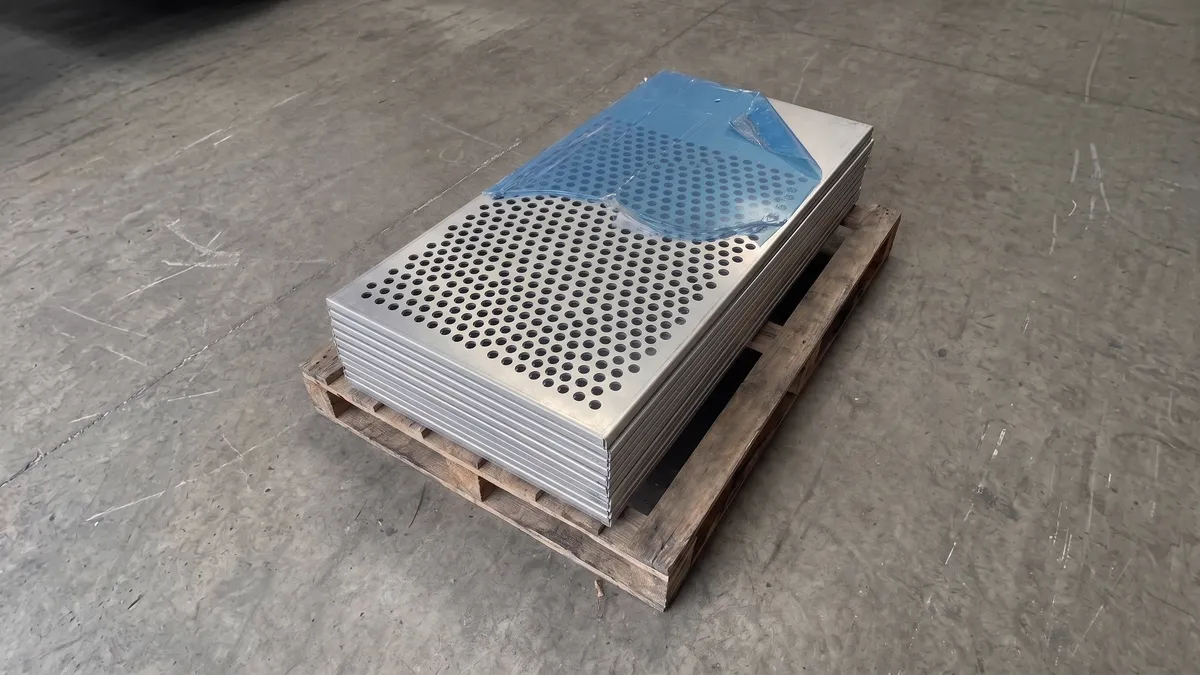 Illustration of laser-perforated aluminium facade panels stacked on a pallet